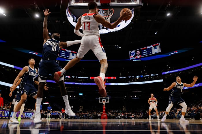 Nov 15, 2023; Washington, District of Columbia, USA; Washington Wizards guard Jordan Poole (13) leaps to pass the ball as Dallas Mavericks forward Tim Hardaway Jr. (10) defends in the first quarter at Capital One Arena. Mandatory Credit: Geoff Burke-USA TODAY Sports